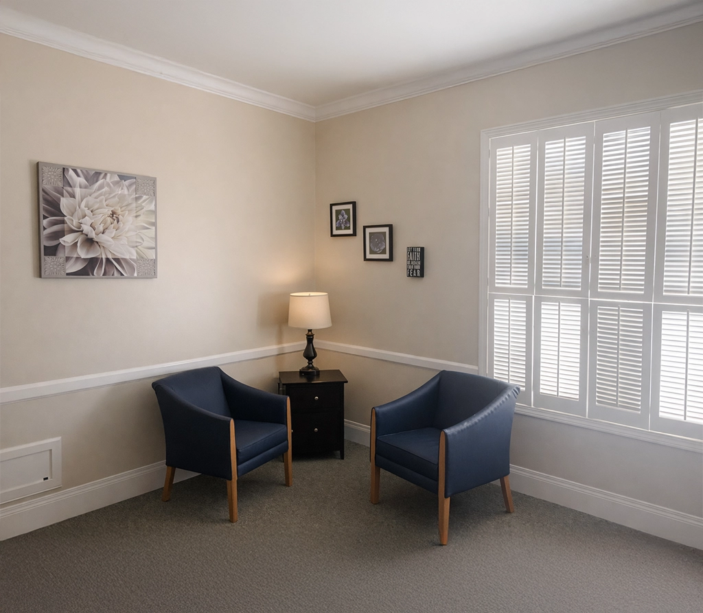 Private counseling office with two chairs and natural light